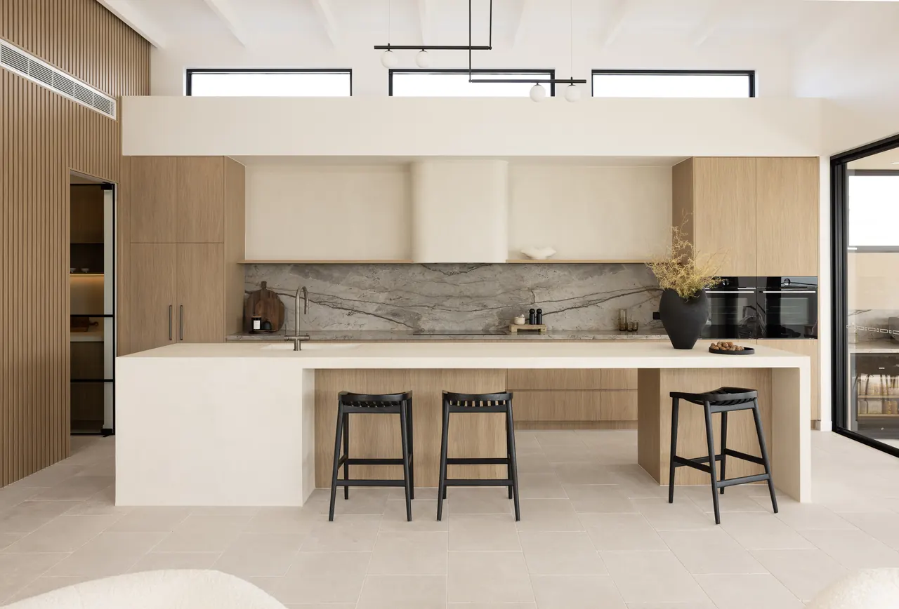 Kitchen with marble splashback, timber joinery and island seating